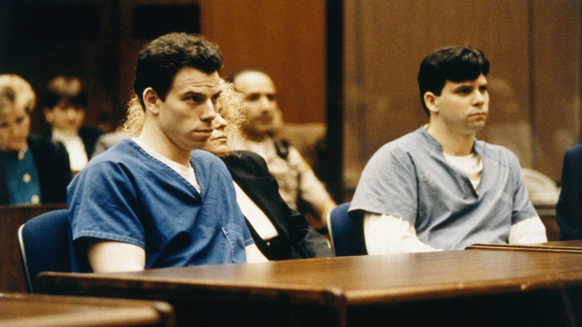 Lyle and Erik Menendez wearing blue prison jumpsuits at their trial in the early 1990s