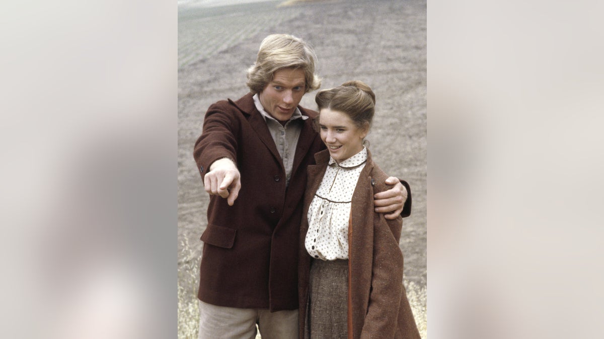 Dean Butler pointing at something as Melissa Gilbert looks on.