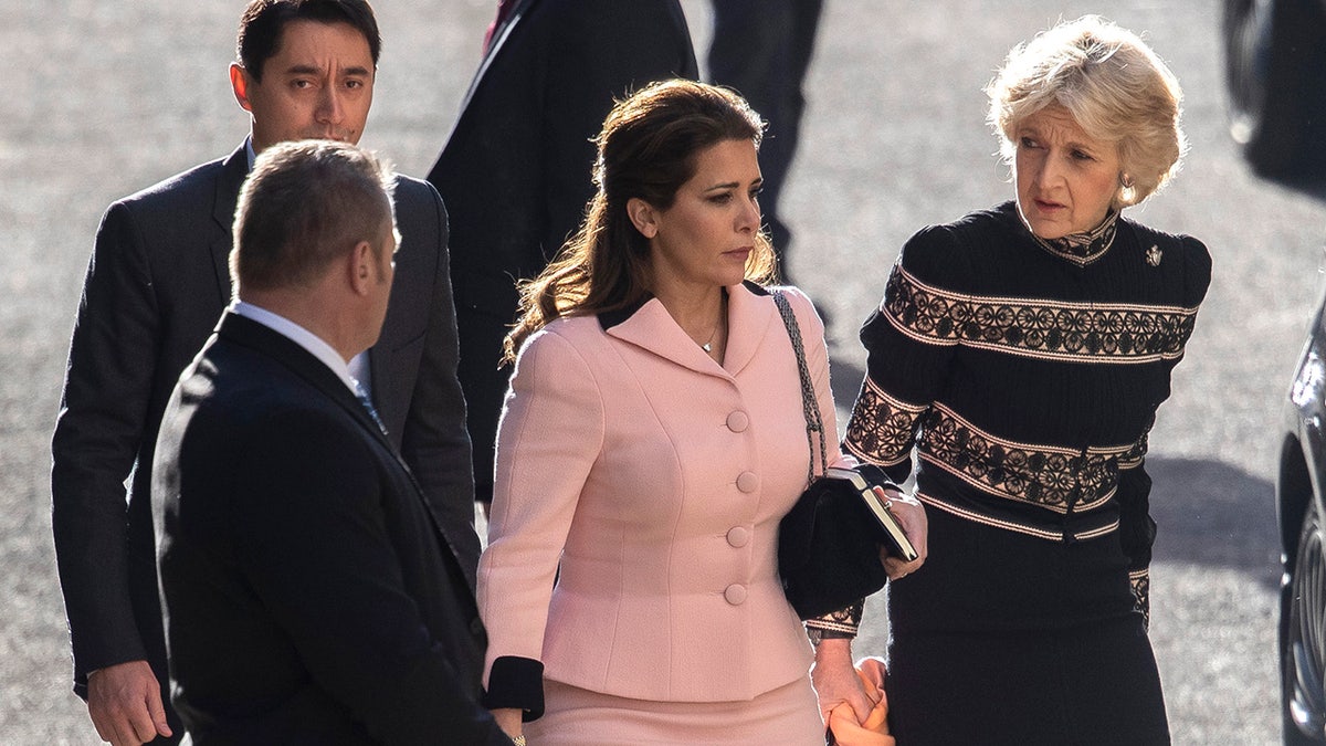 Fional Shackleton wearing a multiprinted sweater walking Princess Haya in a pink blazer.