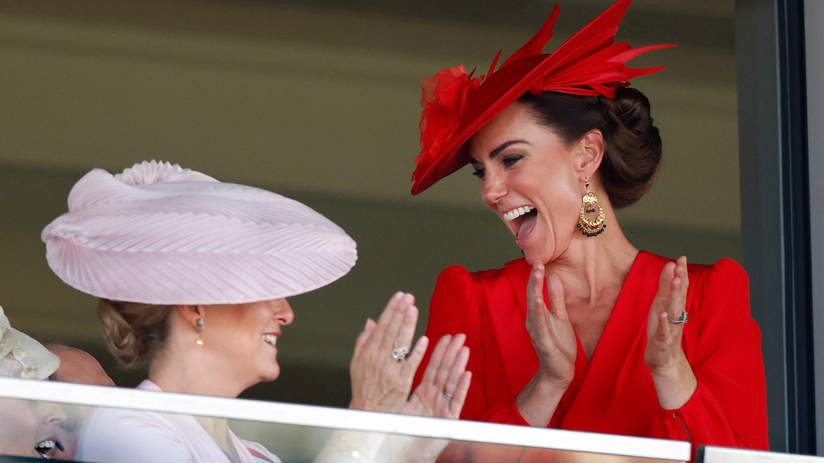 Kate Middleton laughing and applauding with Sophie, Countess of Wessex.