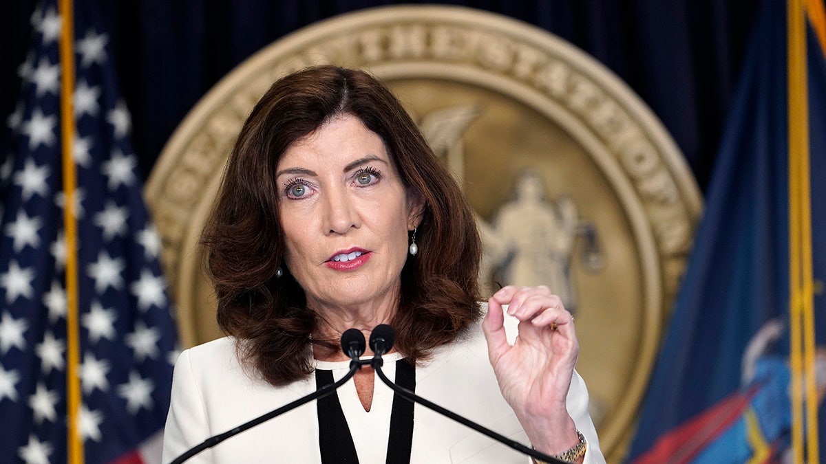 A close-up of Kathy Hochul speaking at the podium