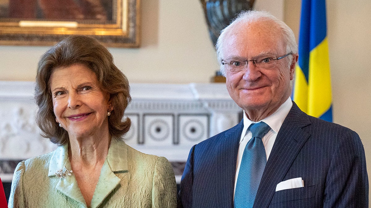 A close-up of King Carl Gustaf and his wife smiling.