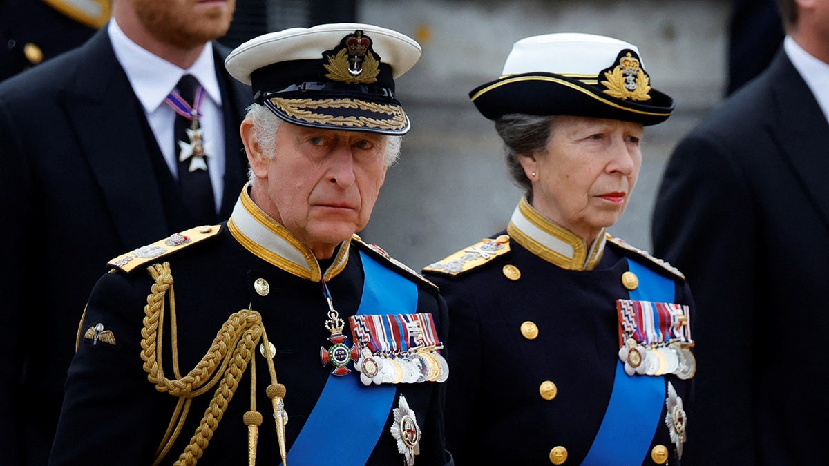 King Charles and Princess Anne wearing matching uniforms looking somber.