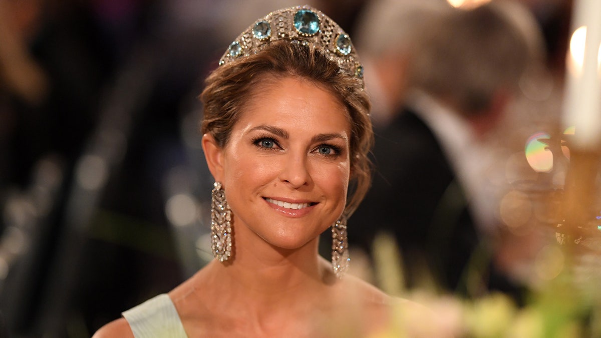 A close-up of Princess Madeline wearing a sparkly tiara with emeralds.