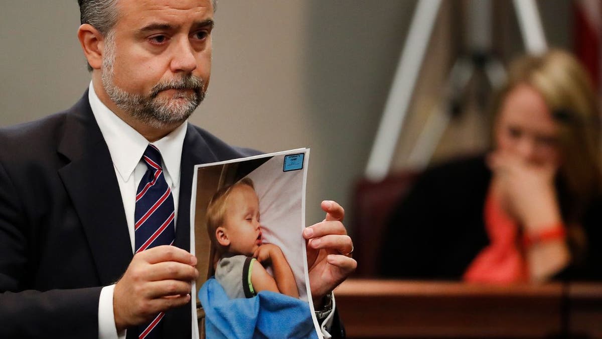 Leanna Taylor cries as defense attorney Maddox Kilgore shows the jury a picture of her son
