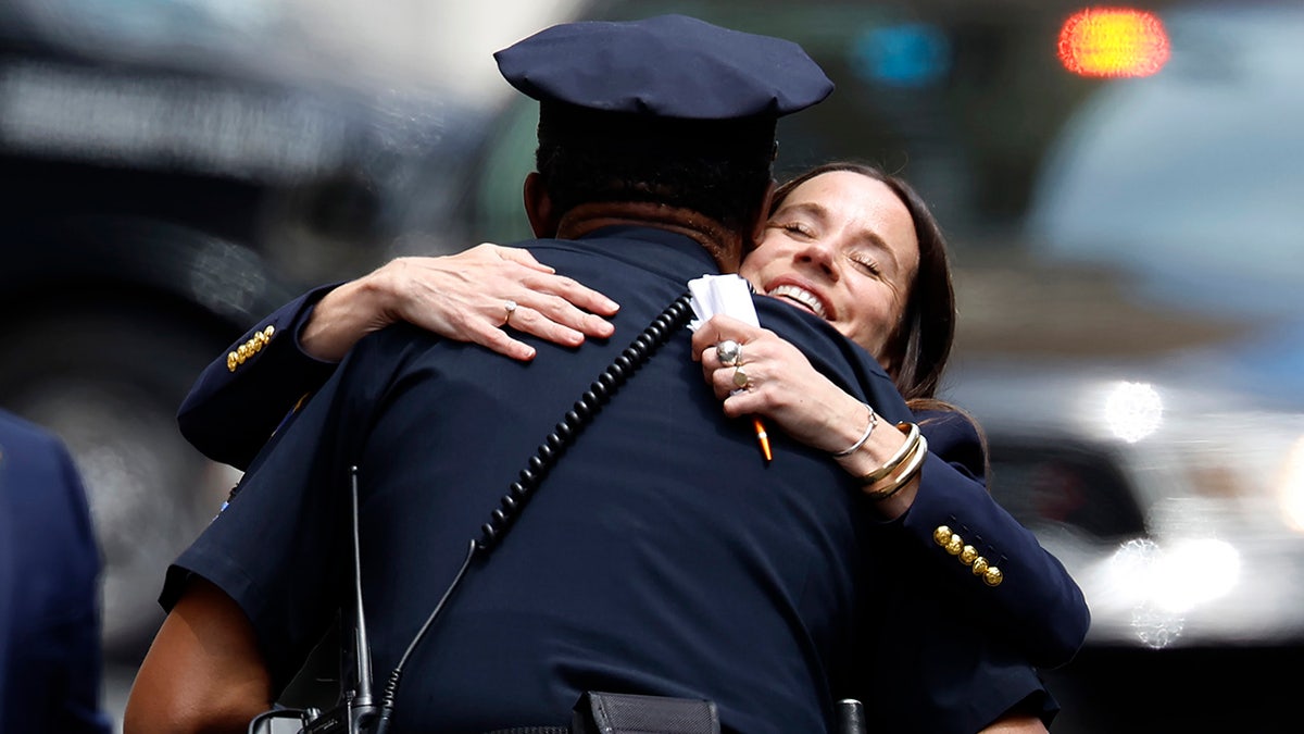 Ashley Biden hugs a police officer as she leaves the J. Caleb Boggs Federal Building during her brother Hunter Biden's trial