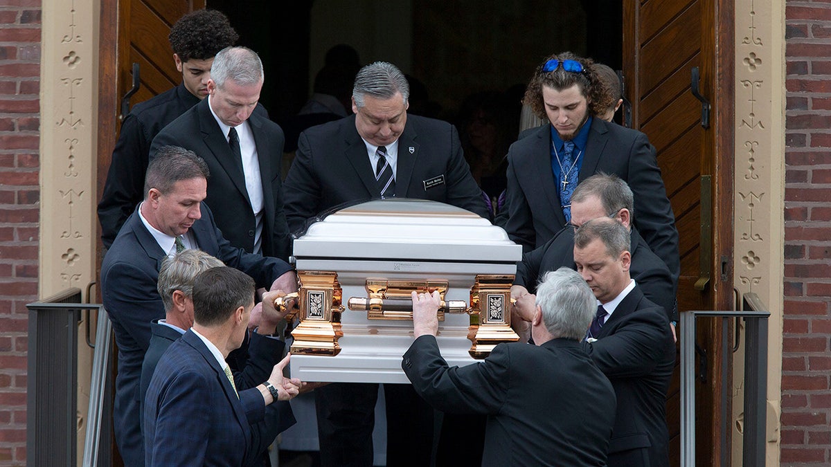Stephanie Parze’s coffin is carried by several men.