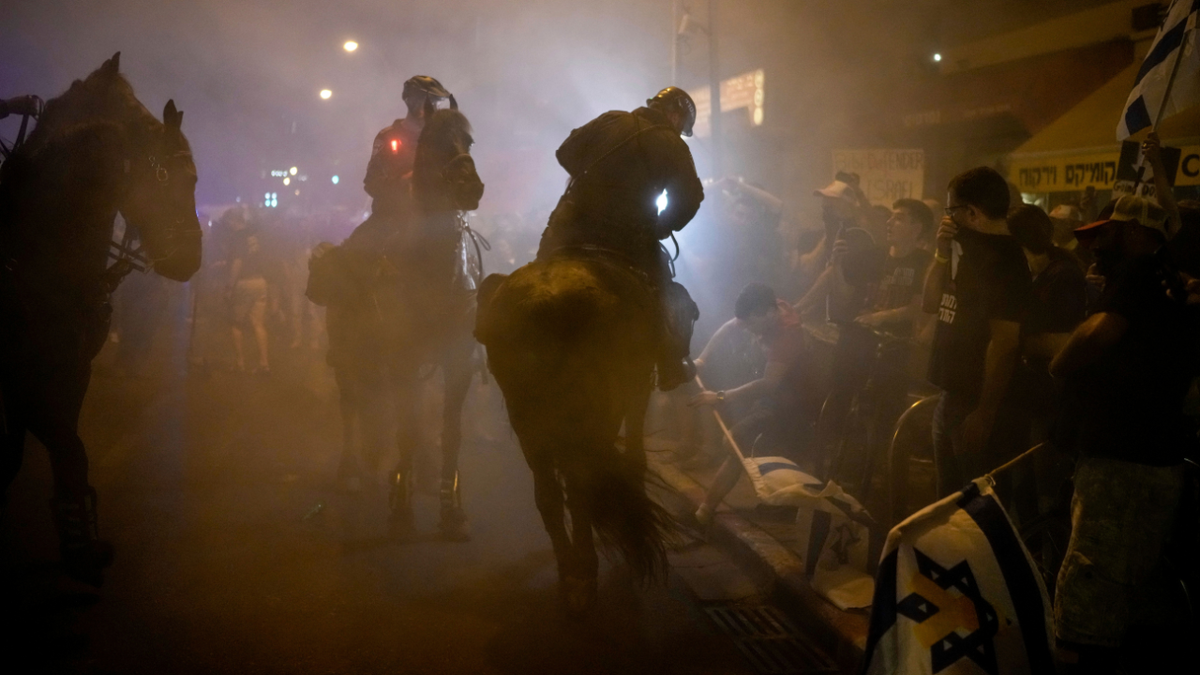Israeli mounted police officers disperse demonstrators