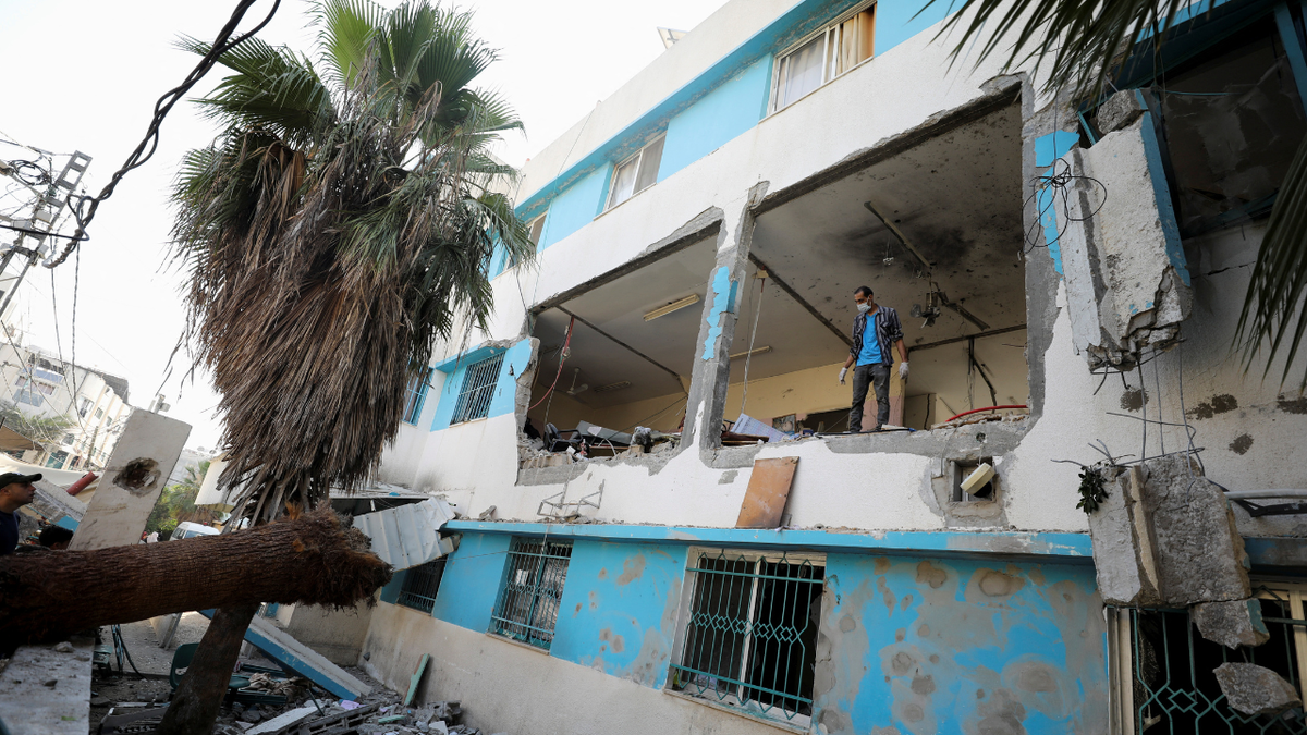 Palestinian inspects damages