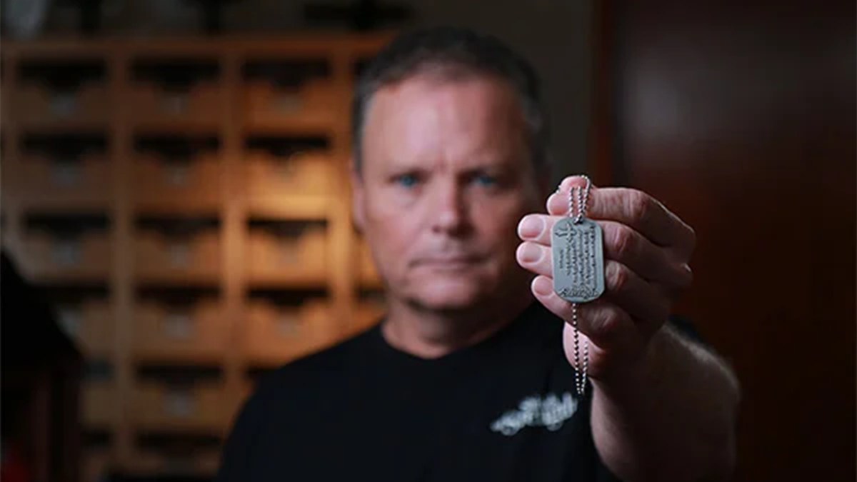 Shields for Strength owners Kenny Vaughan with a religious dog tag.