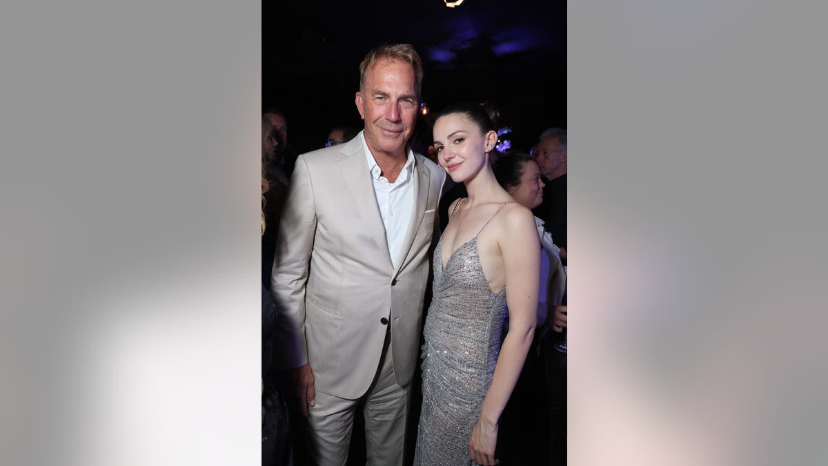 Kevin Costner and Ella Hunt posing together