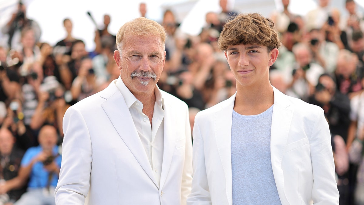 Kevin Costner and Hayes Costner wear white suits at Cannes