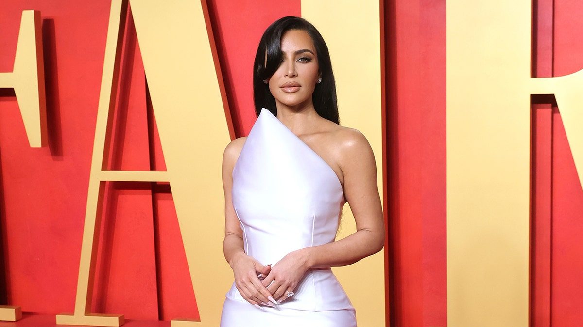 Kim Kardashian posing on the Vanity Fair Oscar Party red carpet