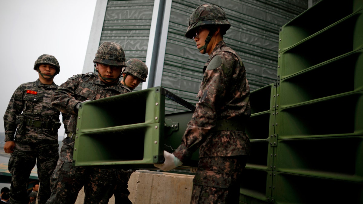 South Korean soldiers dismantle loudspeakers that set up for propaganda broadcasts near the demilitarized zone separating the two Koreas on May 1, 2018.