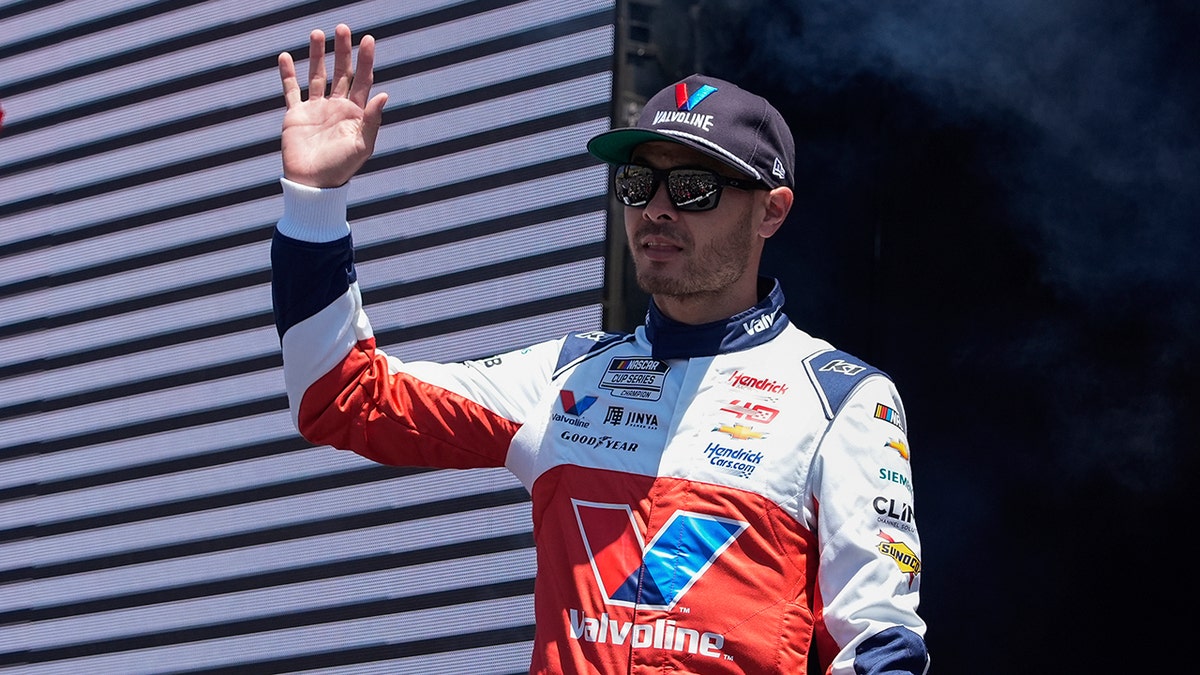 Kyle Larson waves to the crowd