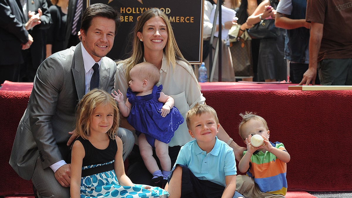 a photo of Mark Wahlberg with wife and children