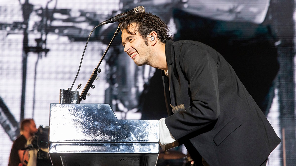 Matty Healy on stage playing piano