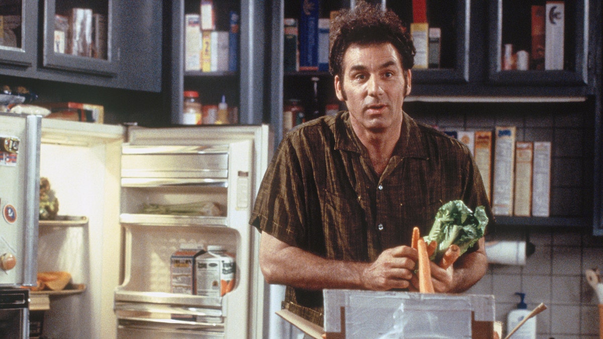 Michael Richards' character Kramer unloads groceries in a scene from Seinfeld