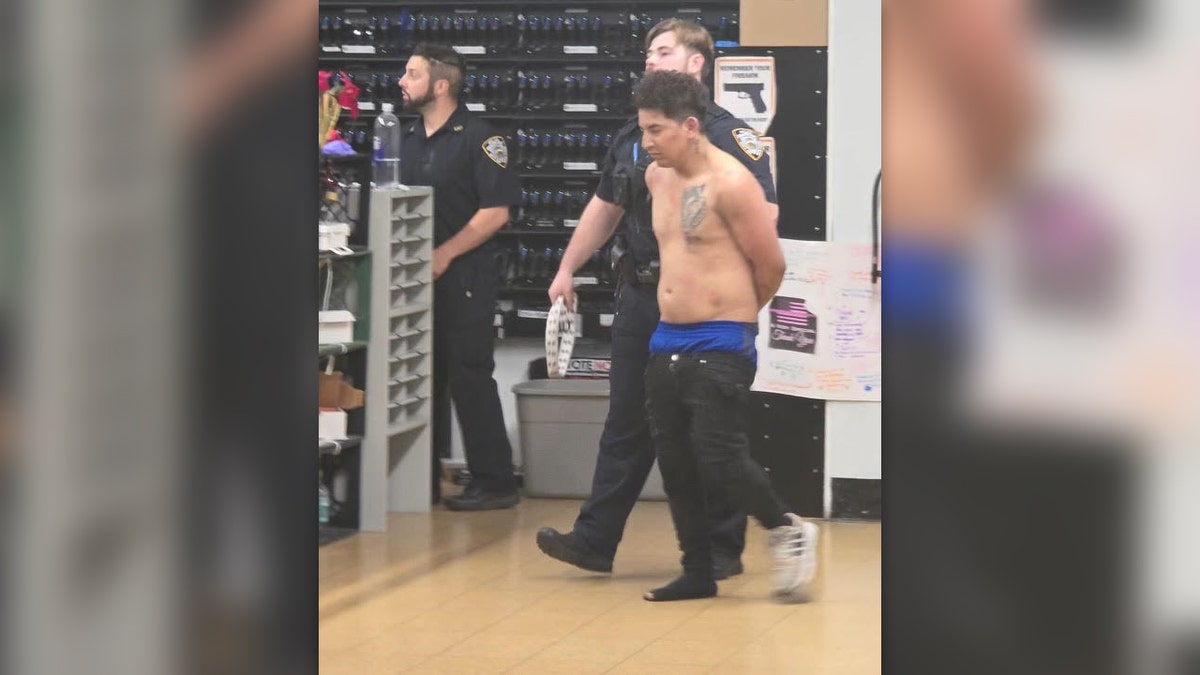 The unnamed suspect is shirtless and missing a shoe after police took him into custody.