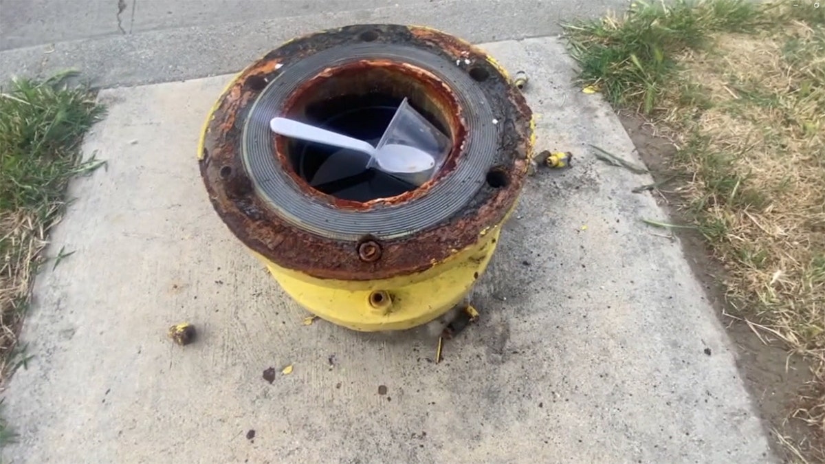 Missing fire hydrant with garbage inside