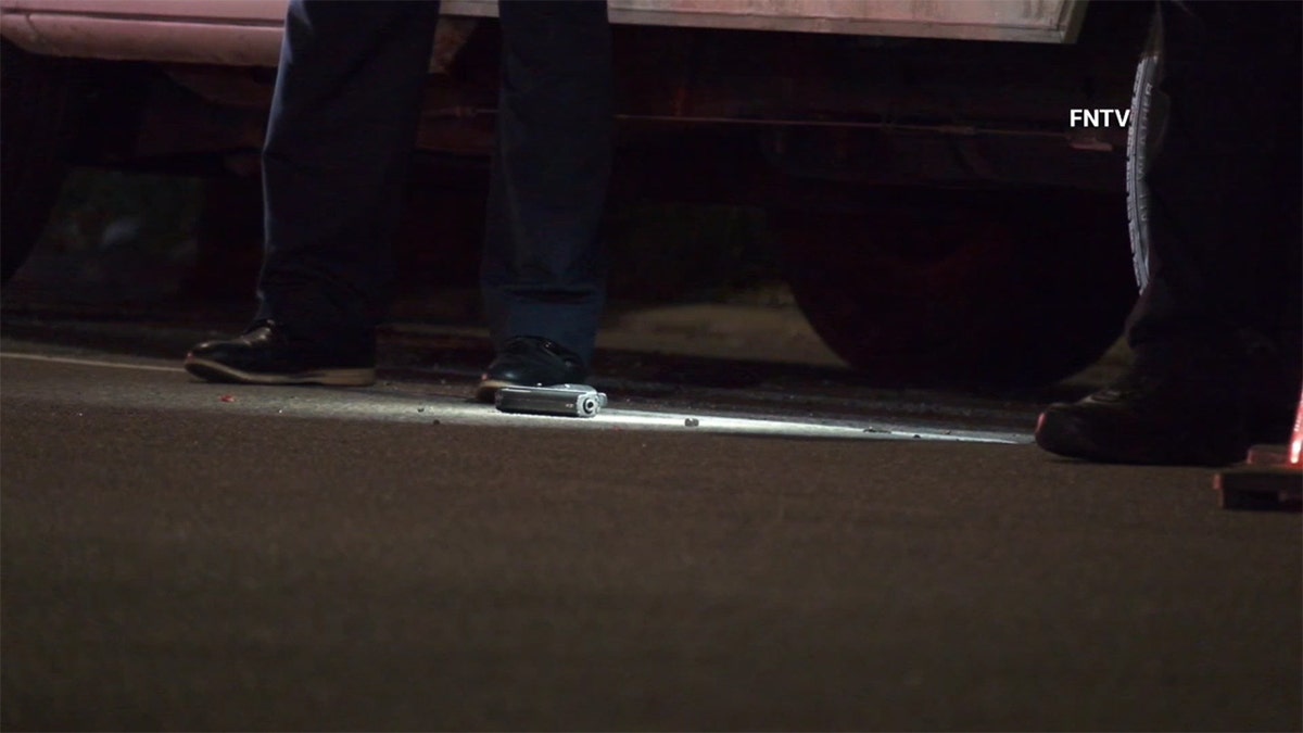 The gun used by the suspect on the floor.