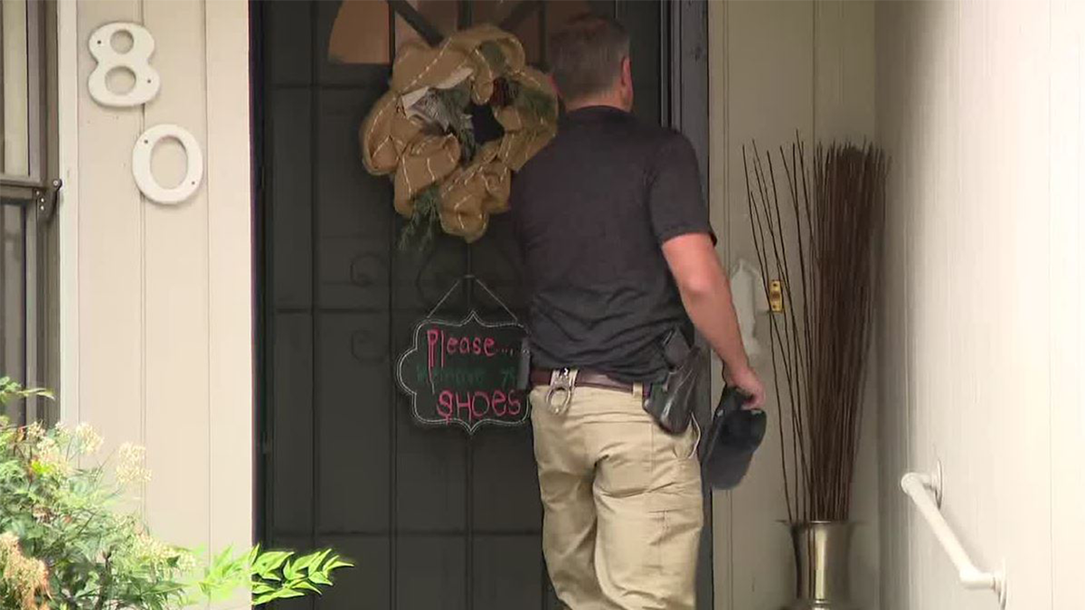 An FBI agent at the door of a home