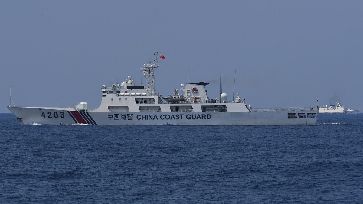 China Coast Guard ships monitor the distribution of fuel and food to fishers by the civilian-led mission Atin Ito (This Is Ours) Coalition, in the disputed South China Sea on May 16, 2024.