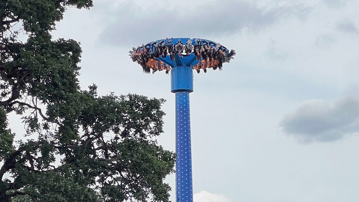 Rider hang upside-down at an amusement park ride