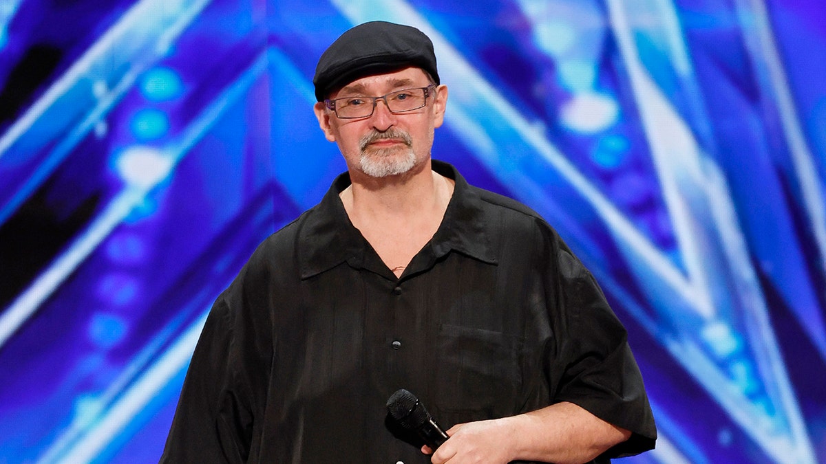 Richard Goodall standing on the America's Got Talent stage