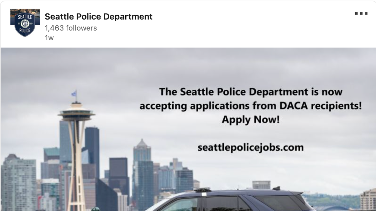 LinkedIn Seattle PD job posting. Police car in foreground, city skyline in background