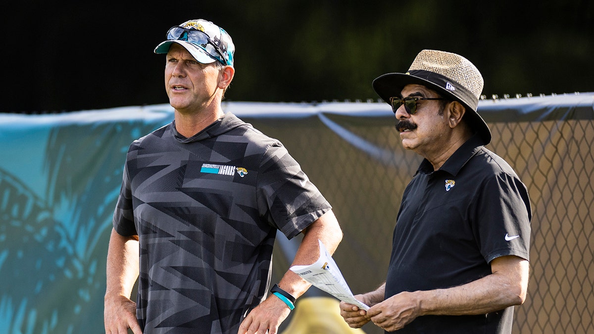 Trent Baalke and Shad Khan look on during a Jacksonville Jaguars practice