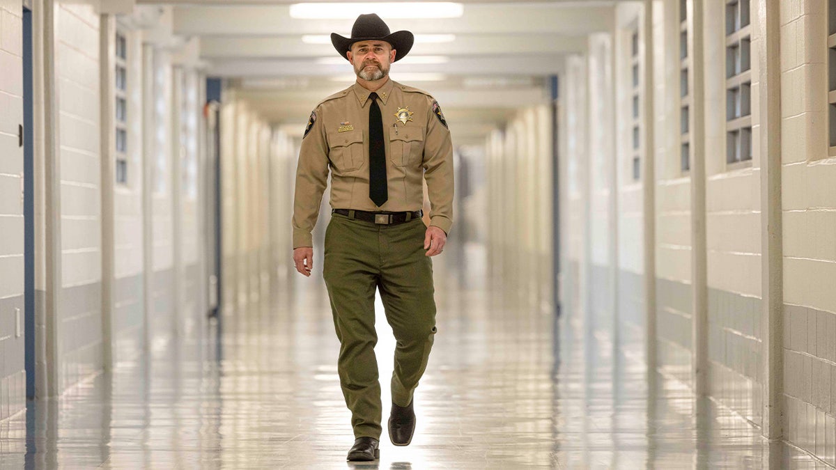 Sheriff Mike Smith walks down hallway