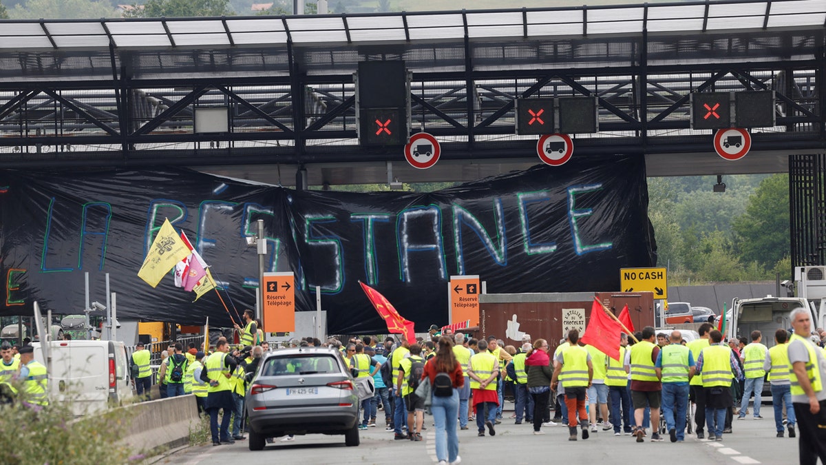 Farmers block the border between Spain and France with a huge banner during a demonstration demanding better conditions ahead of European elections.