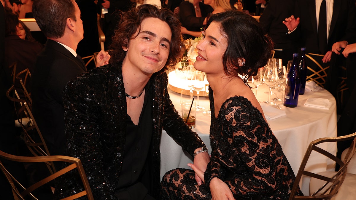 Timothée Chalamet and Kylie Jenner sitting together at a table at the Golden Globes
