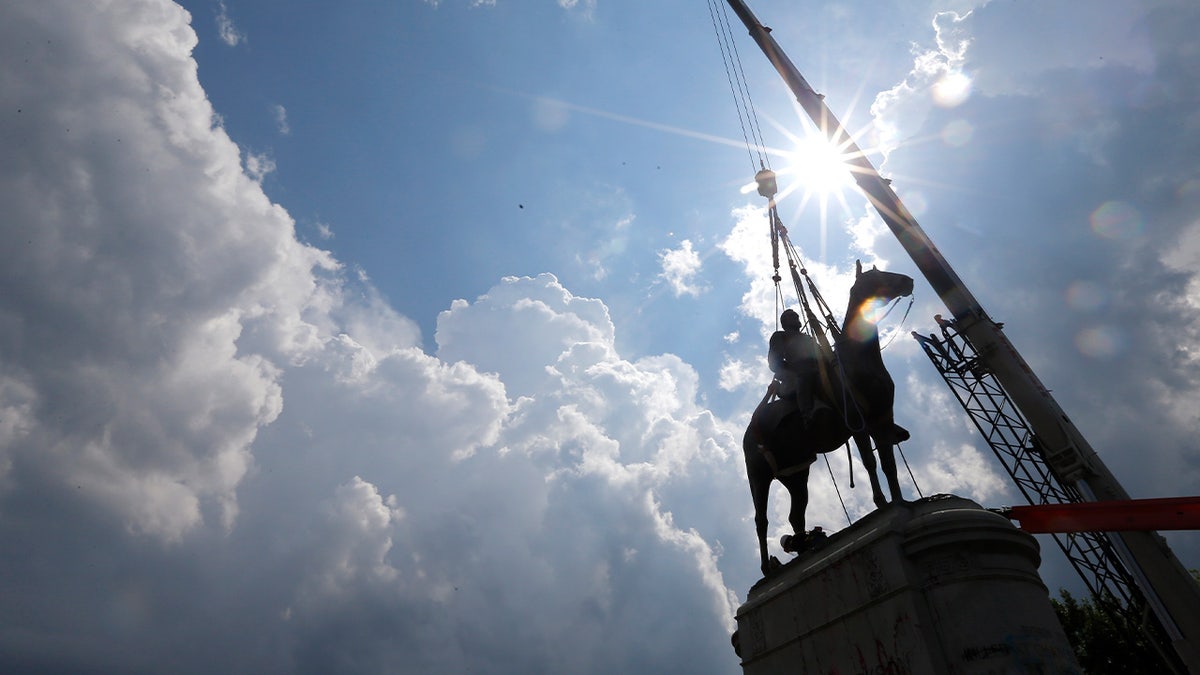 A crew removes the statue of Confederate Gen. Stonewall Jackson