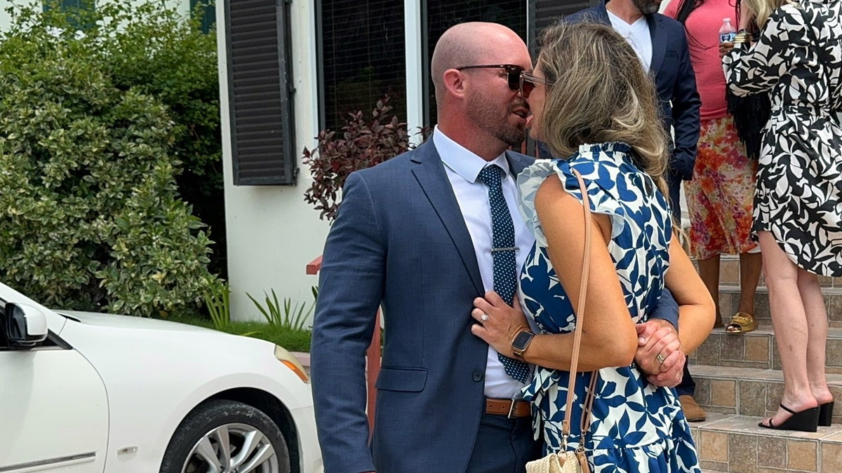 Watsons kiss, reunited outside courthouse