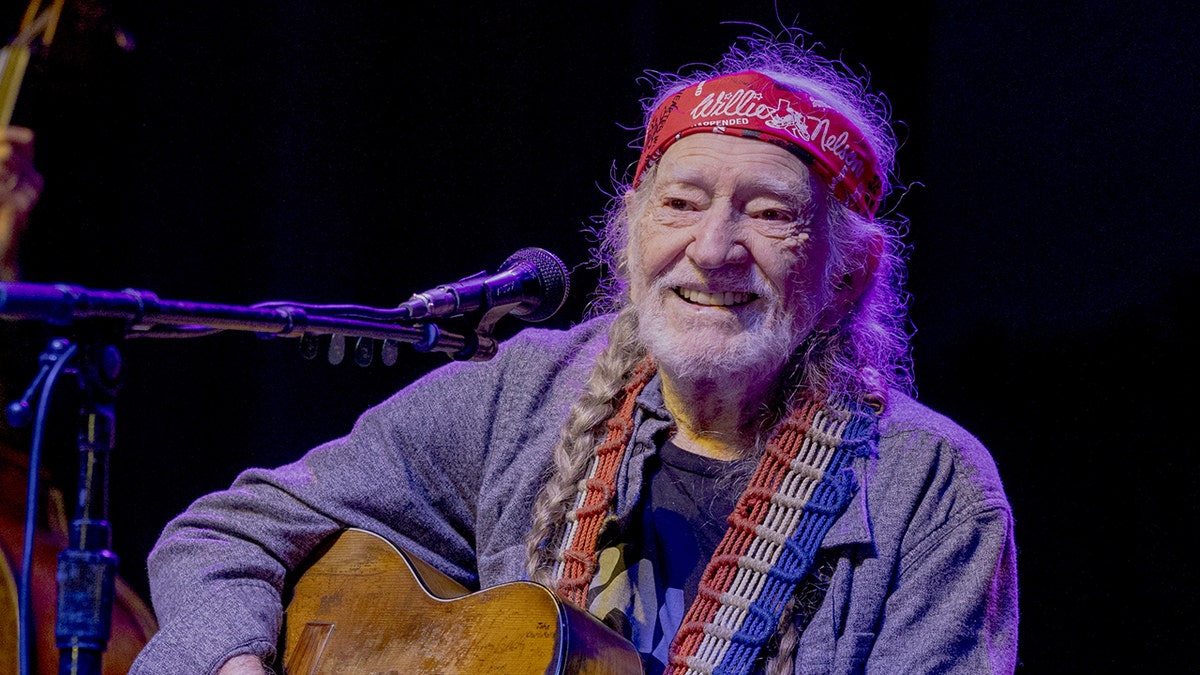 Willie Nelson playing guitar