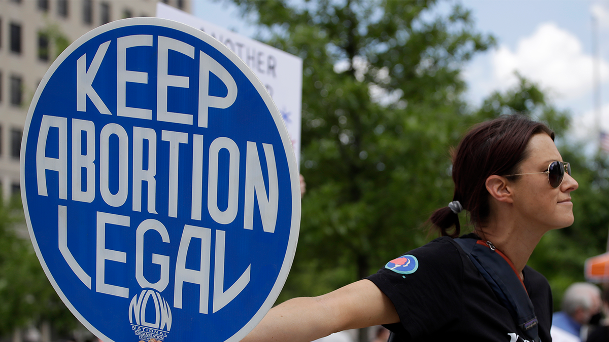 An abortion-rights demonstrator holds a sign