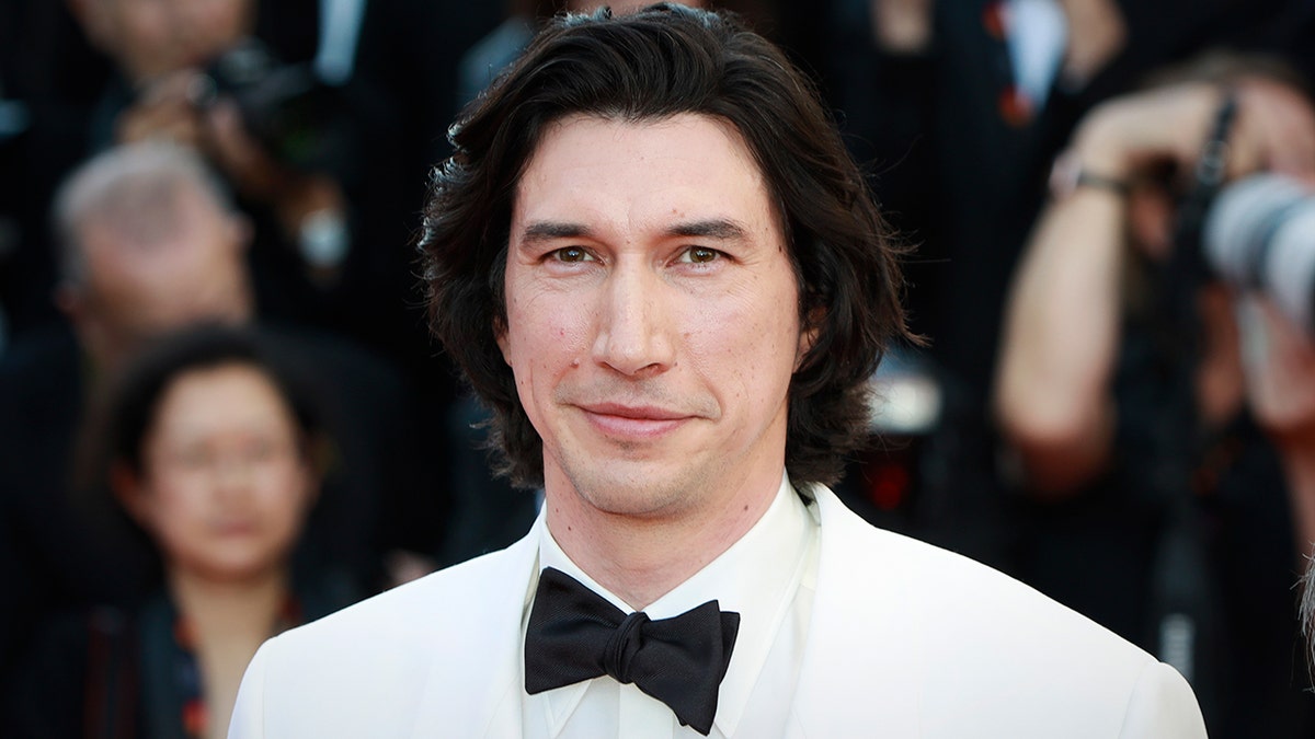 Adam Driver in a white suit at the Cannes Film Festival