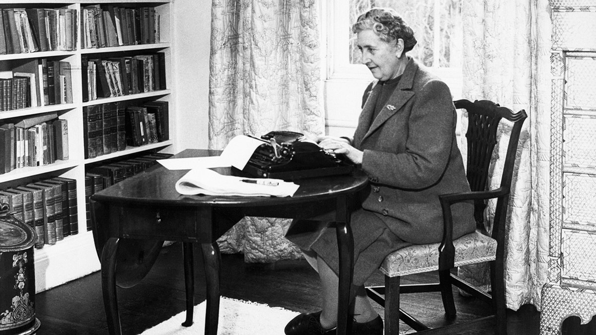 Agatha Christie typing at a desk