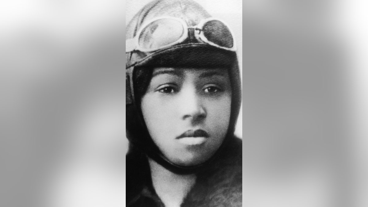 Bessie Coleman wears a flying helmet and goggles