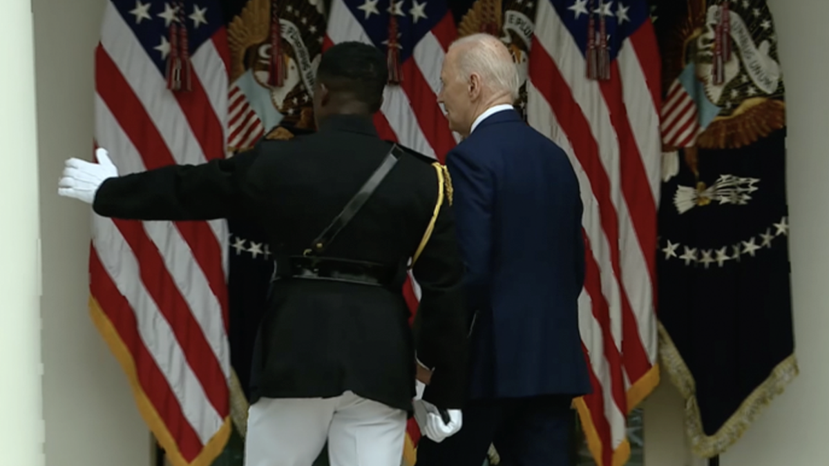 military aide directing President Biden at the White House