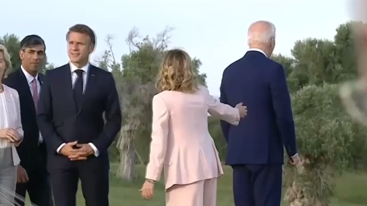 Italian PM Giorgia Meloni taps on Biden's back 