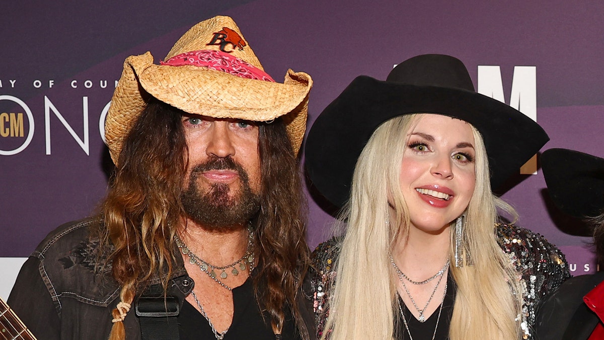Country star Billy Ray Cyrus wears cowboy hat with wife Firerose.