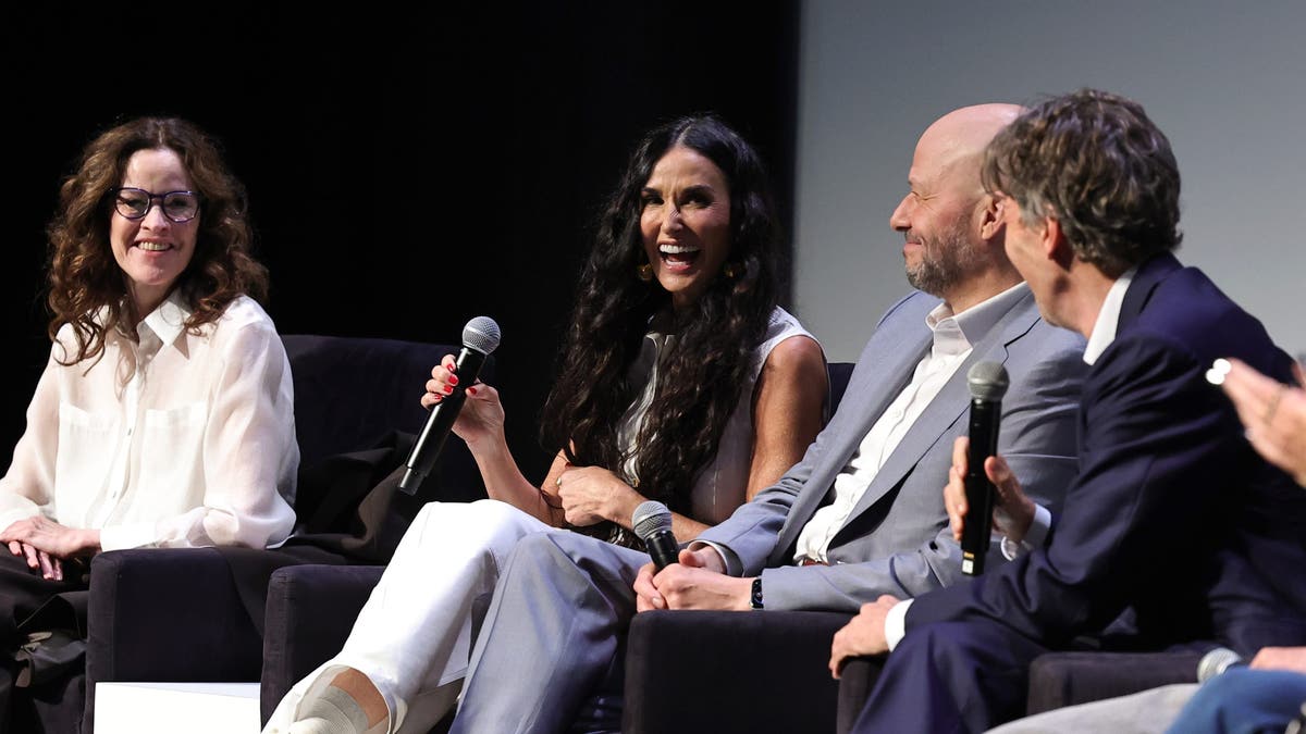 Demi Moore laughing with Brat Pack members on stage at Tribeca