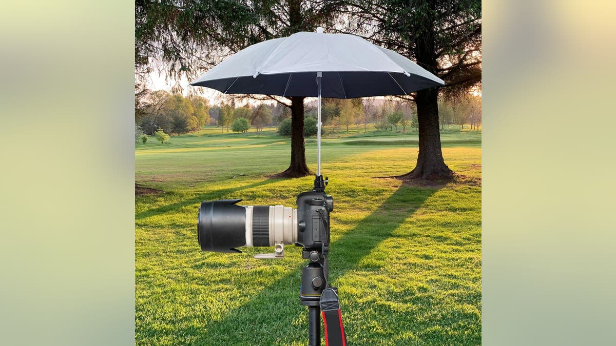 Protect your gear from the elements with a small umbrella.