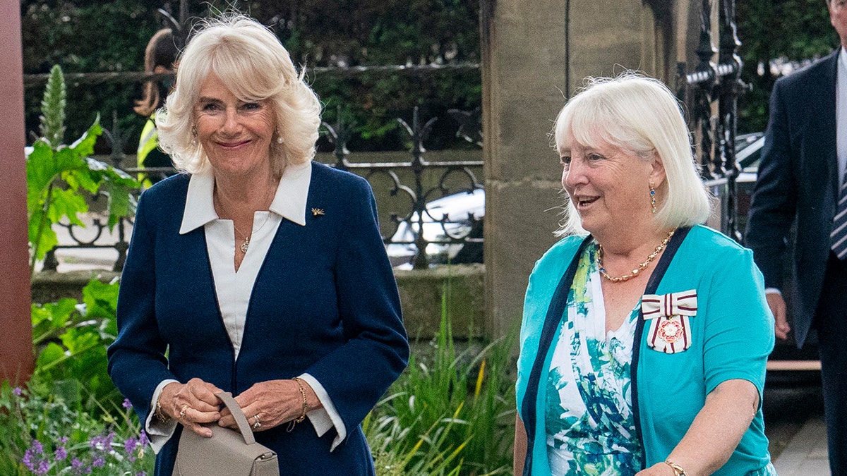 Queen Camilla wearing blue blazer and white blouse at Garden Museum in London