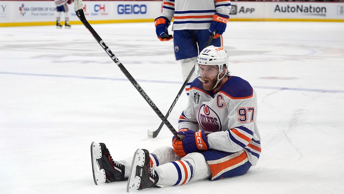 Connor McDavid sits on the ice