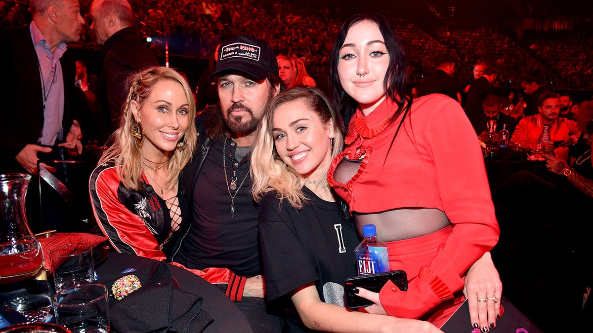 Tish Cyrus, Billy Ray Cyrus, Miley Cyrus and Noah Cyrus smile at the 2017 iHeartRadio Music Awards