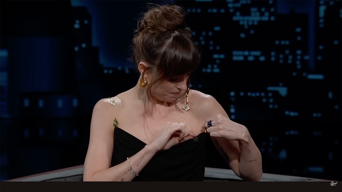 Dakota Johnson fiddles with her broken dress on 'Jimmy Kimmel Live!'